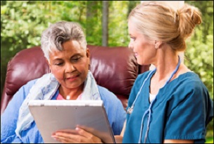 Older African Woman Speaking With a Female Doctor